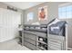 This stylish bedroom has a loft bed with built-in drawers and shelving for optimal organization at 16226 W 94Th Dr, Arvada, CO 80007