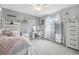Bright bedroom with a large bed, vanity, and lots of space for accessories at 16226 W 94Th Dr, Arvada, CO 80007