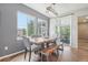 Cozy dining area features a wood table, bench seating, and a sliding glass door to the outdoor patio at 16226 W 94Th Dr, Arvada, CO 80007