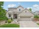 Charming two-story home with a well-maintained front yard and two-car garage, inviting curb appeal at 16226 W 94Th Dr, Arvada, CO 80007
