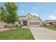 Inviting two-story home with a manicured lawn and a two-car garage, offering an appealing exterior at 16226 W 94Th Dr, Arvada, CO 80007