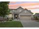 Inviting two-story home featuring a landscaped front yard, cozy porch, and a convenient two-car garage at 16226 W 94Th Dr, Arvada, CO 80007