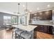 Modern kitchen with granite countertops, stainless steel appliances, and a breakfast bar with seating at 16226 W 94Th Dr, Arvada, CO 80007