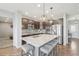 Modern kitchen island with stainless steel appliances, granite countertops, and bar seating at 16226 W 94Th Dr, Arvada, CO 80007