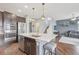 Bright kitchen features stainless steel appliances, center island, and breakfast bar seating at 16226 W 94Th Dr, Arvada, CO 80007