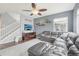 Comfortable living room features stylish gray walls, hardwood floors, and a cozy leather sectional at 16226 W 94Th Dr, Arvada, CO 80007