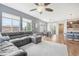 Open-concept living and dining area features hardwood floors, gray walls, and abundant natural light at 16226 W 94Th Dr, Arvada, CO 80007