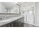 Spacious main bathroom featuring double sinks, large mirrors, and shower at 16226 W 94Th Dr, Arvada, CO 80007