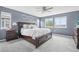 Large primary bedroom featuring a ceiling fan, three windows and a love wall decor at 16226 W 94Th Dr, Arvada, CO 80007