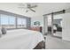 Spacious main bedroom with windows, carpet, and a barn door at 16226 W 94Th Dr, Arvada, CO 80007