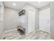 Inviting mudroom features tile flooring, a shoe rack, and coat hooks at 16226 W 94Th Dr, Arvada, CO 80007