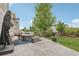 Inviting patio area with comfortable seating, a fire pit, and a well-maintained lawn, ideal for relaxation at 16226 W 94Th Dr, Arvada, CO 80007