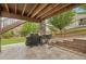 Covered patio with stone supports and built-in gas grill offers the perfect outdoor entertaining space at 16226 W 94Th Dr, Arvada, CO 80007