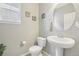 Neutral powder room featuring a pedestal sink, decor and window at 16226 W 94Th Dr, Arvada, CO 80007