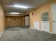 Finished basement area featuring carpet, neutral walls and built-in shelves and cabinets at 14503 E Wagon Trail Dr, Aurora, CO 80015