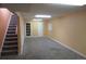 Finished basement area featuring carpet, neutral walls and access to the stairwell at 14503 E Wagon Trail Dr, Aurora, CO 80015