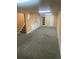Finished basement with carpet, neutral walls and built-in shelves, plus access to the stairwell at 14503 E Wagon Trail Dr, Aurora, CO 80015