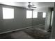 Bedroom boasts ample natural light from three windows, complemented by a ceiling fan and mirrored closet at 14503 E Wagon Trail Dr, Aurora, CO 80015