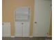White built-in cabinet and shelves provide stylish storage near a white door at 14503 E Wagon Trail Dr, Aurora, CO 80015