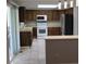 Eat in kitchen with warm wood cabinetry, tile floors and stainless steel refrigerator at 14503 E Wagon Trail Dr, Aurora, CO 80015
