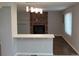 Open floor plan featuring a breakfast bar and a brick fireplace at 14503 E Wagon Trail Dr, Aurora, CO 80015