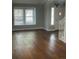Sun-filled living room features gleaming hardwood floors and neutral paint at 14503 E Wagon Trail Dr, Aurora, CO 80015
