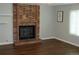 Bright living room boasts a brick fireplace and hardwood floors at 14503 E Wagon Trail Dr, Aurora, CO 80015