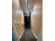 Long stairwell with carpeted steps and pale orange walls, lit with three spotlights at 14503 E Wagon Trail Dr, Aurora, CO 80015