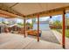 Relaxing backyard with covered patio, raised garden beds, blue shed, and walkway at 2201 Lima St, Aurora, CO 80010