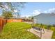 Lush backyard with a swing set, detached garage, and brick house in background at 2201 Lima St, Aurora, CO 80010