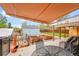 Backyard under covered patio, showcasing raised garden beds, an outdoor grill, and blue shed at 2201 Lima St, Aurora, CO 80010