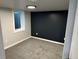 Finished basement featuring plush carpeting, natural light from window well, and clean, modern design at 2201 Lima St, Aurora, CO 80010