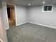 Large basement with carpeting, base trim and a bright window at 2201 Lima St, Aurora, CO 80010