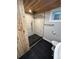 Updated bathroom featuring a wood ceiling, tiled shower, and sleek fixtures at 2201 Lima St, Aurora, CO 80010