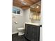 Bathroom featuring a wood ceiling, modern vanity with a gold faucet, and tiled flooring at 2201 Lima St, Aurora, CO 80010