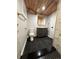 Updated bathroom with a wood ceiling, modern vanity, and tiled floor and shower at 2201 Lima St, Aurora, CO 80010