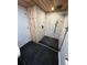 Updated bathroom featuring a tiled shower with black fixtures and a rainfall showerhead at 2201 Lima St, Aurora, CO 80010