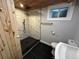 Updated bathroom featuring a wood ceiling, tiled shower, and sleek fixtures at 2201 Lima St, Aurora, CO 80010