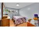 Bright bedroom featuring wood floors, a comfy queen-size bed, and plenty of natural light at 2201 Lima St, Aurora, CO 80010