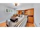 Bright bedroom featuring wood floors, built-in storage, a ceiling fan, and a large window at 2201 Lima St, Aurora, CO 80010