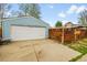 Blue two-car garage with a white door and concrete driveway at 2201 Lima St, Aurora, CO 80010