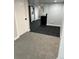 Hallway from finished basement with LVP to carpet at 2201 Lima St, Aurora, CO 80010