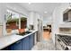 Modern kitchen featuring a stainless steel refrigerator, gas range, and white countertops at 2201 Lima St, Aurora, CO 80010