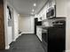 Sleek kitchen featuring stainless steel appliances and white cabinets at 2201 Lima St, Aurora, CO 80010