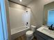 Bathroom featuring white subway tile in shower, white vanity, and modern fixtures at 9476 Yampa Ct, Commerce City, CO 80022