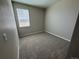 Cozy bedroom featuring plush carpeting, neutral walls, and a bright window at 9476 Yampa Ct, Commerce City, CO 80022