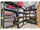 Organized basement storage area with durable shelving units containing boxes, containers, and household items at 15079 E Poundstone Pl, Aurora, CO 80015