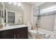 Bathroom features decorative tiled walls, a single sink vanity, and a tub and shower combination at 15079 E Poundstone Pl, Aurora, CO 80015