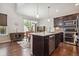 Well-equipped kitchen with stainless steel appliances, a large island, and hardwood floors at 15079 E Poundstone Pl, Aurora, CO 80015