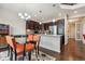 Modern kitchen with dark cabinets, stainless steel appliances, granite countertops, and an adjacent dining area at 15079 E Poundstone Pl, Aurora, CO 80015